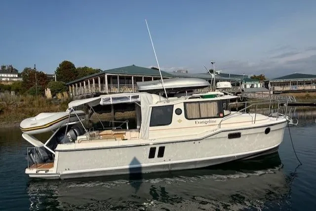 Evangaline Yacht Photos Pics 2022 Ranger Tugs R-25 boat docked in a marina, featuring a sleek design.