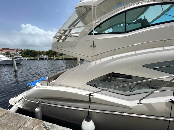 Summer Girl Yacht Photos Pics 2007 Cruisers Yachts 497 Sport Sedan docked by the waterfront.