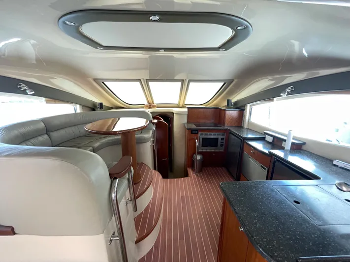 Summer Girl Yacht Photos Pics Interior of 2007 Cruisers Yachts 497 Sport Sedan with modern kitchen and seating area.
