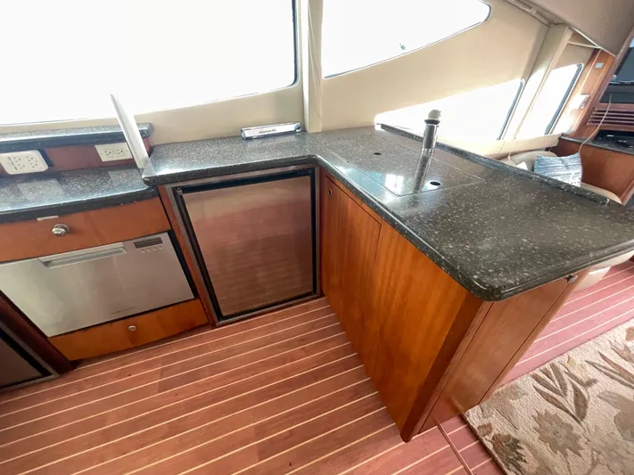 Summer Girl Yacht Photos Pics 2007 Cruisers Yachts 497 Sport Sedan kitchen with modern appliances and sleek countertops.