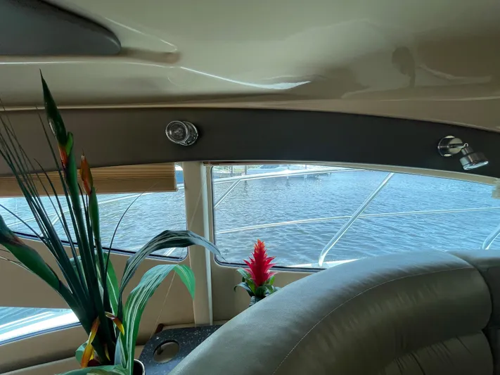 Summer Girl Yacht Photos Pics Interior view of 2007 Cruisers Yachts 497 Sport Sedan with plants and water outside.