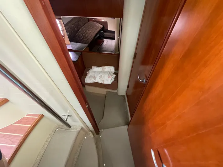 Summer Girl Yacht Photos Pics 2007 Cruisers Yachts 497 Sport Sedan interior hallway with wooden finishes and stairs.