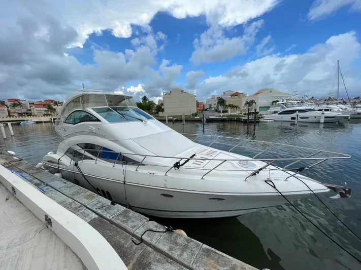 Summer Girl Yacht Photos Pics 2007 Cruisers Yachts 497 Sport Sedan docked at a marina under a cloudy sky.