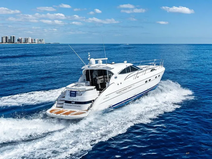  Yacht Photos Pics 2003 Neptunus 56 Express yacht cruising on open blue ocean under clear skies.