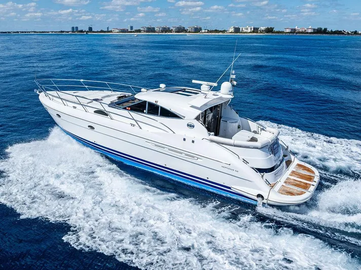  Yacht Photos Pics 2003 Neptunus 56 Express yacht cruising on open water, clear sky in background.