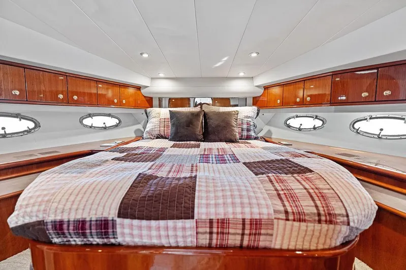  Yacht Photos Pics Luxurious 2003 Neptunus 56 Express yacht bedroom with wood cabinetry and quilted bedding.