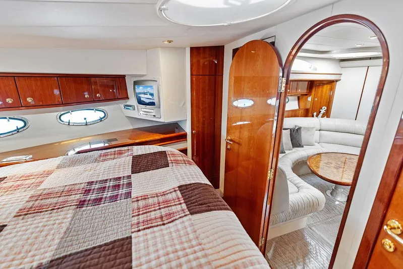  Yacht Photos Pics Luxurious 2003 Neptunus 56 Express yacht interior with cozy bedroom and elegant living area.