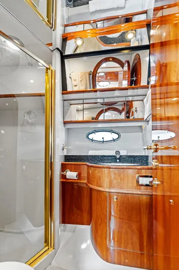  Yacht Photos Pics Luxurious bathroom in 2003 Neptunus 56 Express yacht with wood accents and modern fixtures.