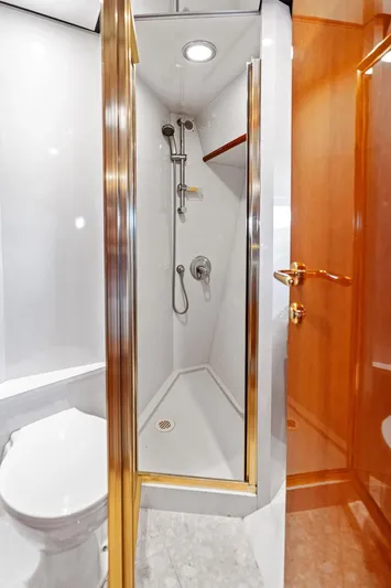  Yacht Photos Pics Luxurious bathroom in 2003 Neptunus 56 Express yacht with modern shower and elegant wood accents.