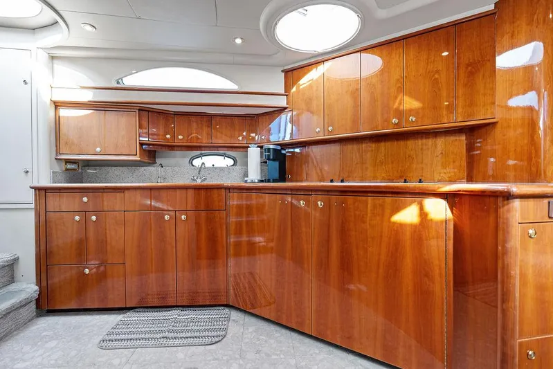  Yacht Photos Pics Luxurious wooden kitchen interior of 2003 Neptunus 56 Express yacht.