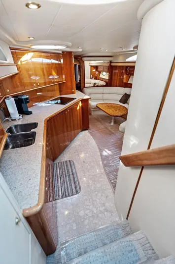  Yacht Photos Pics Luxurious interior of 2003 Neptunus 56 Express yacht with modern kitchen and seating area.