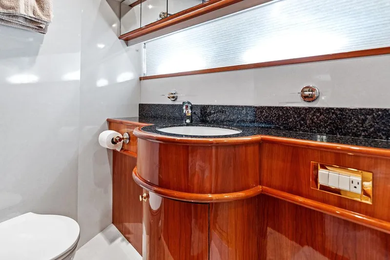  Yacht Photos Pics Luxurious bathroom in 2003 Neptunus 56 Express yacht with wood cabinetry and modern fixtures.