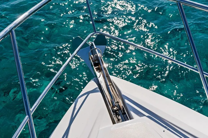  Yacht Photos Pics Bow of 2003 Neptunus 56 Express yacht over clear turquoise water.