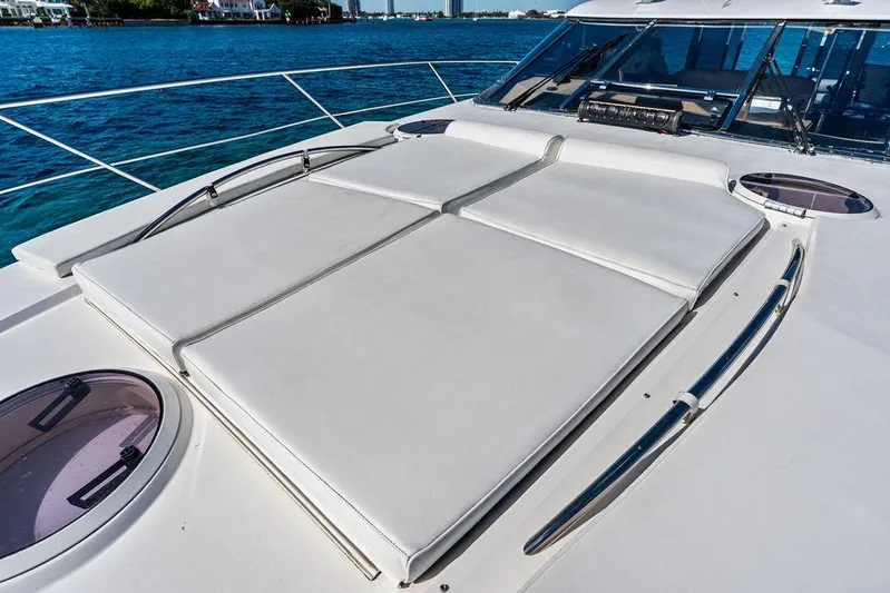  Yacht Photos Pics 2003 Neptunus 56 Express yacht with sunbathing deck, sleek design, and ocean view.