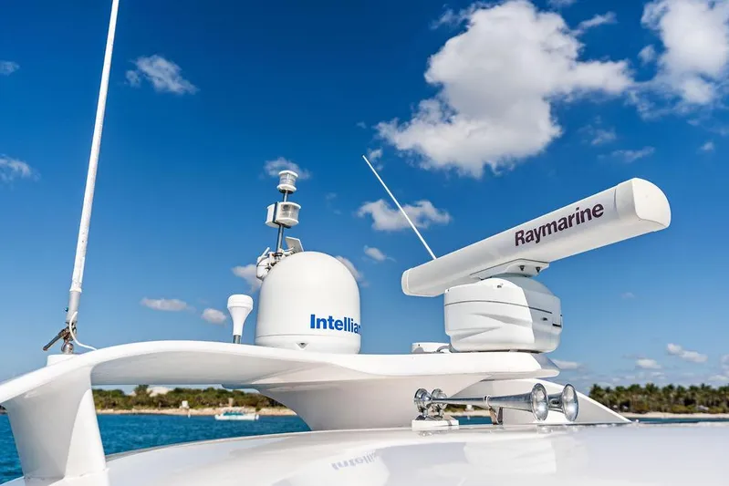  Yacht Photos Pics Radar and satellite equipment on a 2003 Neptunus 56 Express yacht under a clear blue sky.