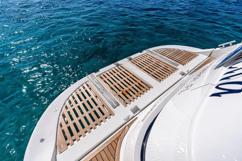  Yacht Photos Pics 2003 Neptunus 56 Express yacht deck with wooden slats over clear blue water.