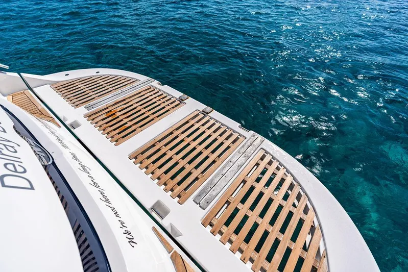  Yacht Photos Pics 2003 Neptunus 56 Express yacht with wooden deck over clear blue water.