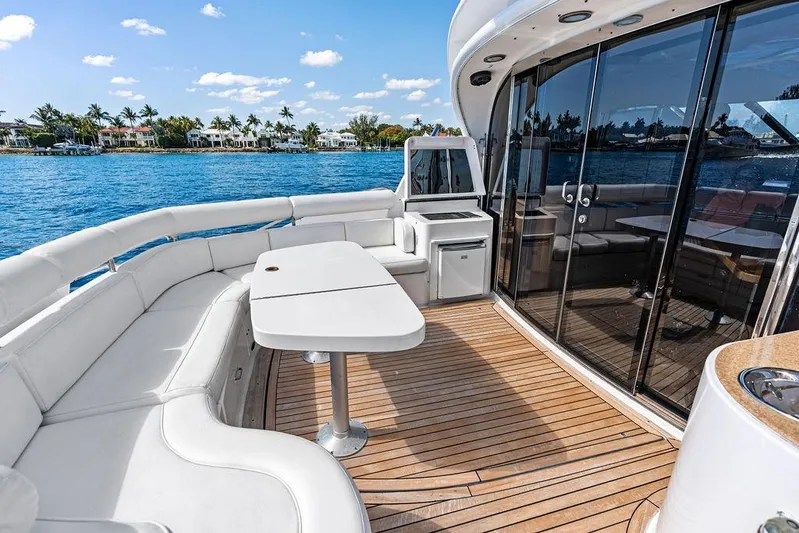  Yacht Photos Pics Luxury yacht deck with seating, table, and ocean view; Neptunus 56 Express, 2003 model.