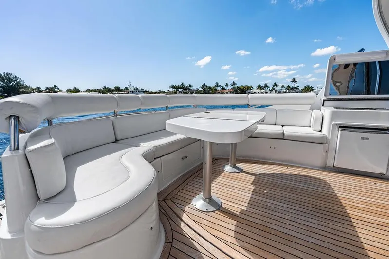  Yacht Photos Pics Luxurious 2003 Neptunus 56 Express yacht deck with white seating and table.