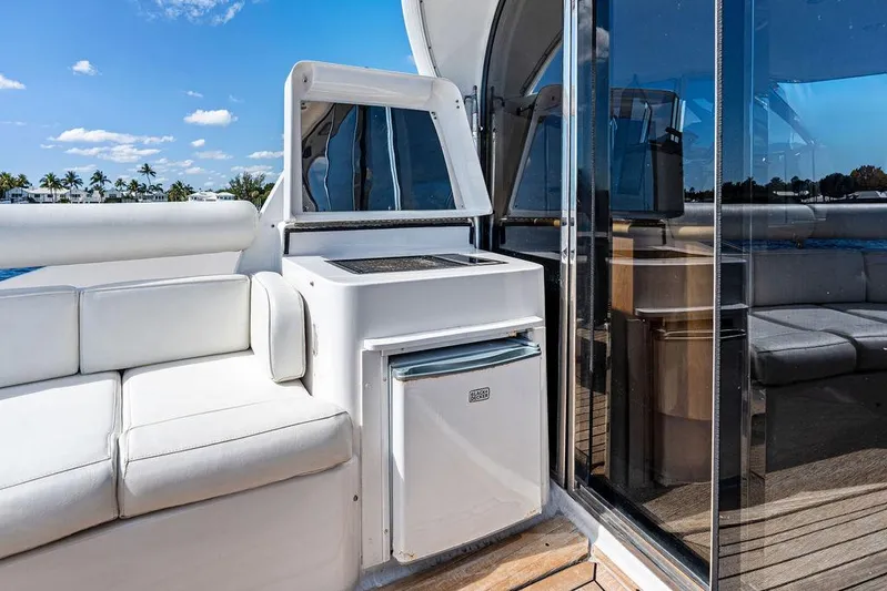  Yacht Photos Pics 2003 Neptunus 56 Express yacht interior with white seating and mini fridge.