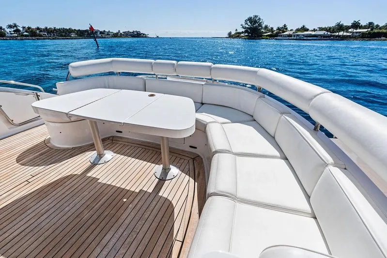  Yacht Photos Pics 2003 Neptunus 56 Express yacht with white seating and table on deck, ocean view.