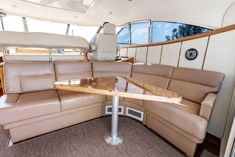  Yacht Photos Pics Luxurious interior of 2003 Neptunus 56 Express yacht with leather seating and wooden table.