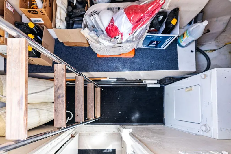  Yacht Photos Pics Storage area in a 2003 Neptunus 56 Express yacht with supplies and a washing machine.