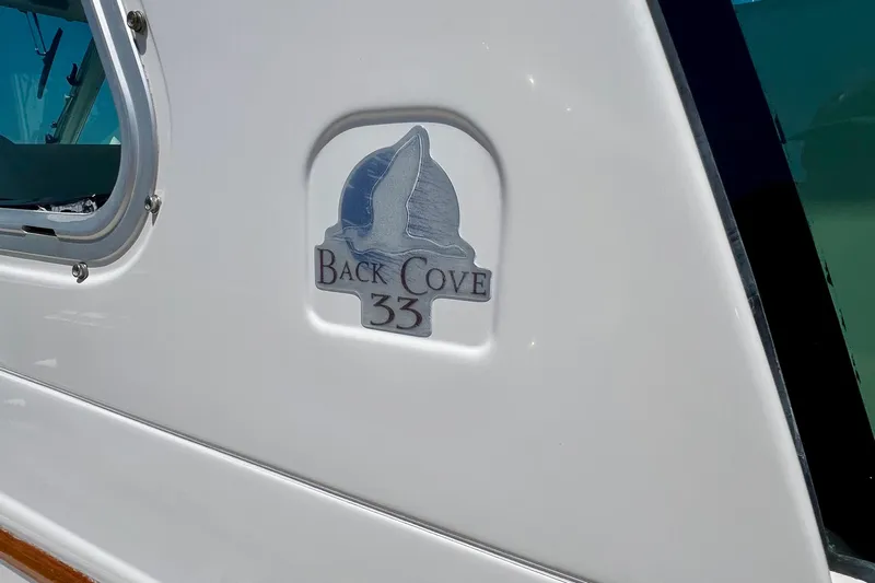 Cabrillo Yacht Photos Pics 2008 Back Cove 33 Express boat logo on white hull near window.