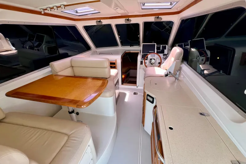 Cabrillo Yacht Photos Pics 2008 Back Cove 33 Express interior with helm, seating, and dining area.