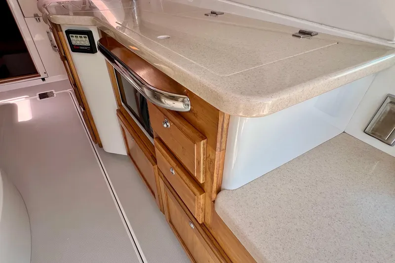 Cabrillo Yacht Photos Pics 2008 Back Cove 33 Express interior with wooden cabinetry and modern appliances.