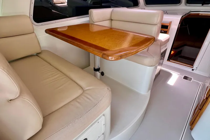 Cabrillo Yacht Photos Pics 2008 Back Cove 33 Express interior with beige seating and wooden table.