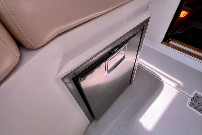 Cabrillo Yacht Photos Pics 2008 Back Cove 33 Express interior with stainless steel fridge and beige seating.