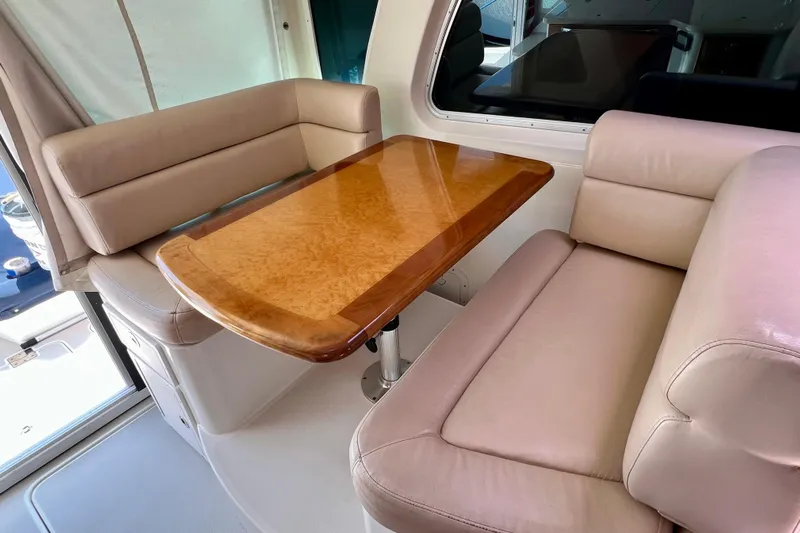 Cabrillo Yacht Photos Pics Luxurious seating area with wooden table on 2008 Back Cove 33 Express yacht.