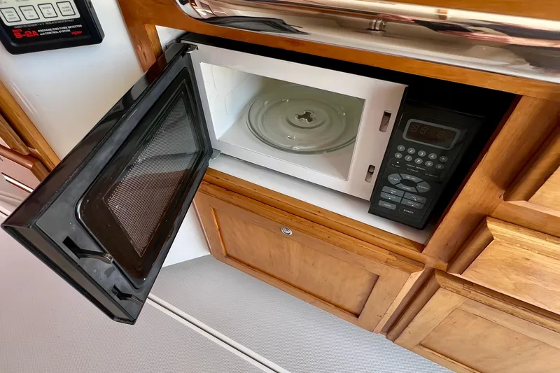 Cabrillo Yacht Photos Pics Open microwave in 2008 Back Cove 33 Express yacht kitchen.