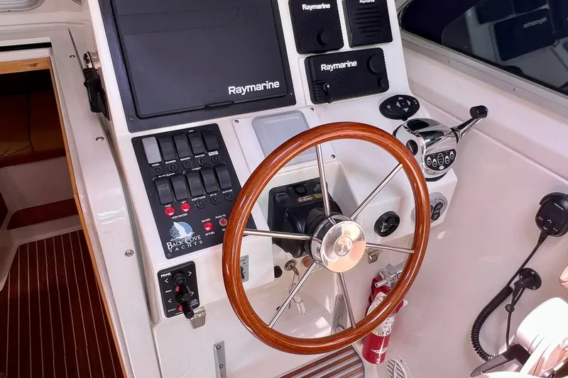 Cabrillo Yacht Photos Pics 2008 Back Cove 33 Express helm with Raymarine electronics and wooden steering wheel.