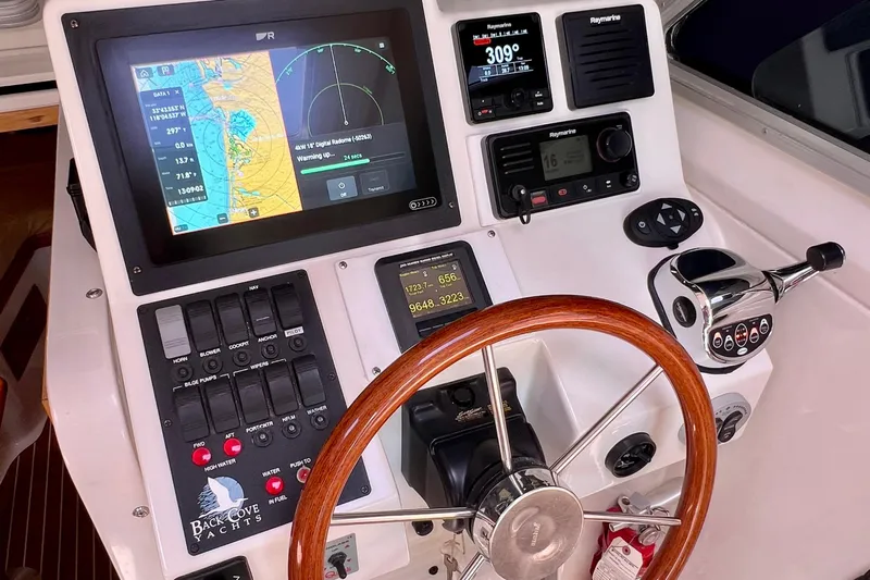 Cabrillo Yacht Photos Pics 2008 Back Cove 33 Express helm with navigation controls and wooden steering wheel.