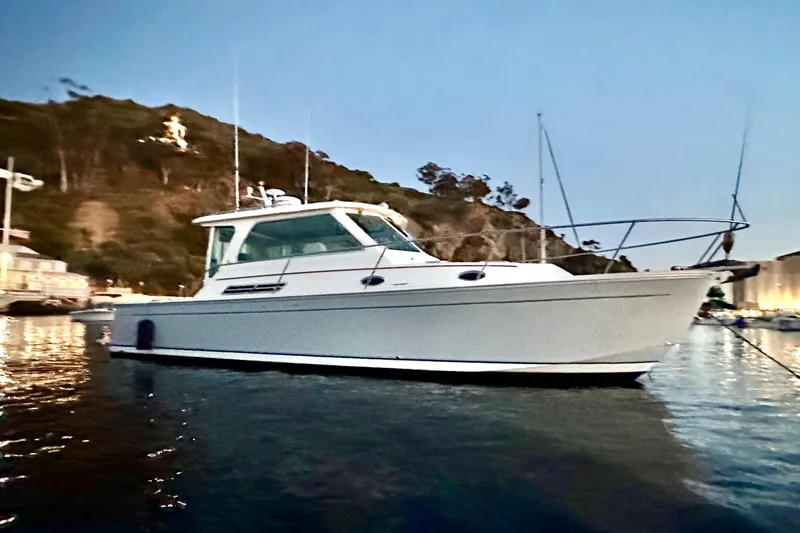 Cabrillo Yacht Photos Pics 2008 Back Cove 33 Express boat anchored in scenic coastal waters at dusk.