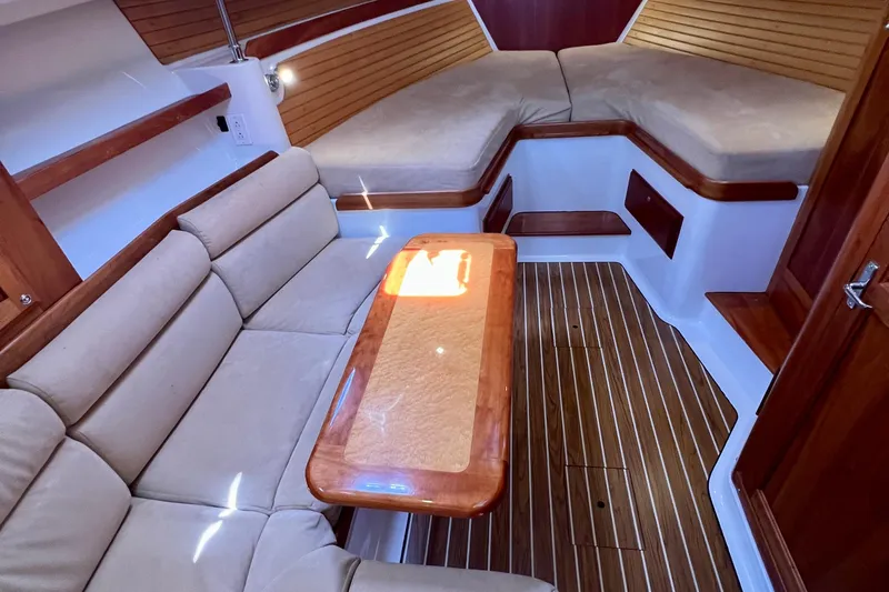 Cabrillo Yacht Photos Pics 2008 Back Cove 33 Express cabin interior with beige seating and wooden accents.