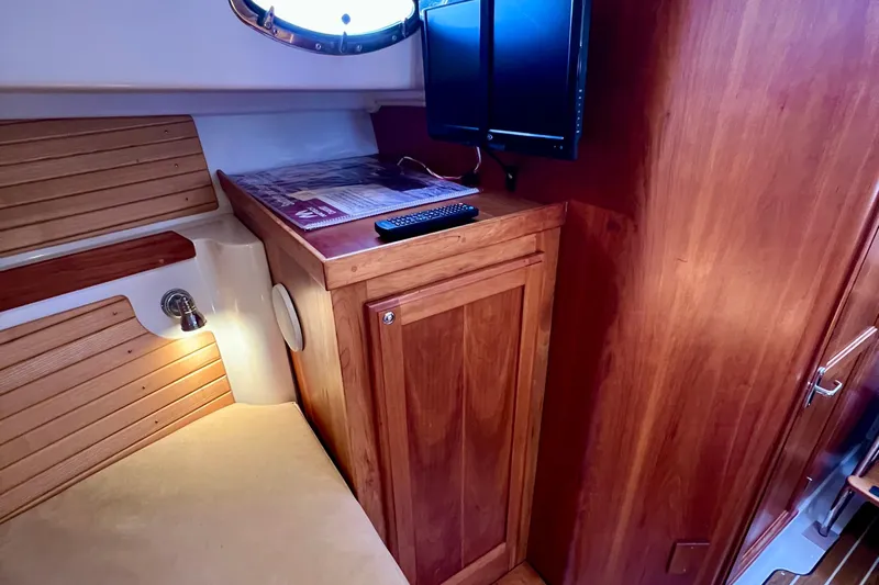 Cabrillo Yacht Photos Pics 2008 Back Cove 33 Express cabin interior with wood finish and mounted TV.