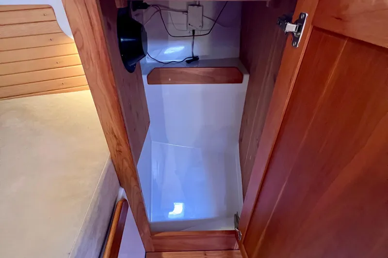 Cabrillo Yacht Photos Pics 2008 Back Cove 33 Express cabin interior with wooden finish and storage space.