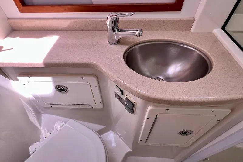 Cabrillo Yacht Photos Pics 2008 Back Cove 33 Express bathroom sink with beige countertop and chrome faucet.