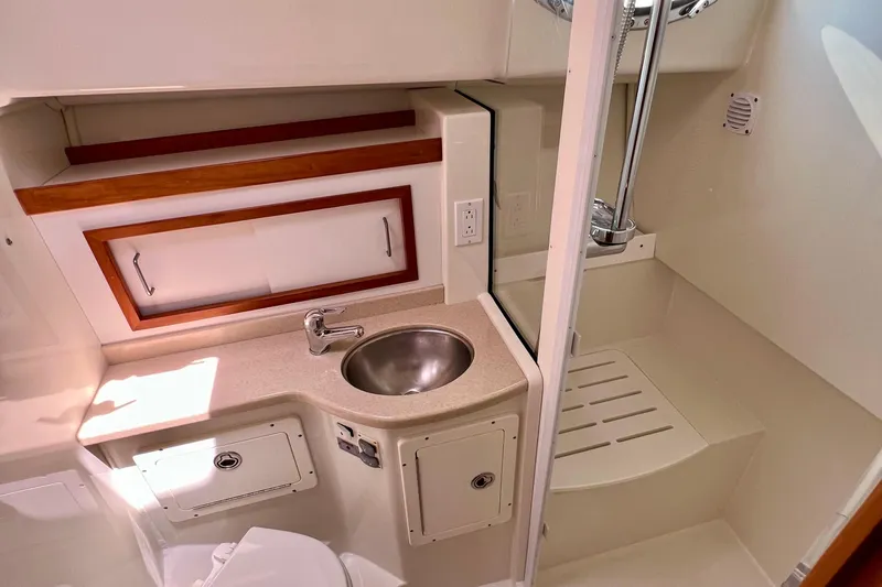 Cabrillo Yacht Photos Pics 2008 Back Cove 33 Express bathroom with sink, shower, and storage cabinets.