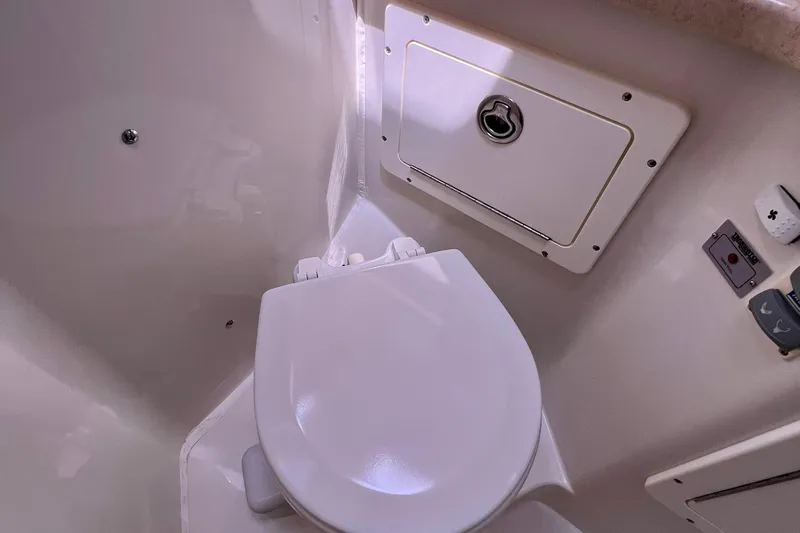 Cabrillo Yacht Photos Pics 2008 Back Cove 33 Express boat bathroom with white toilet and storage compartment.