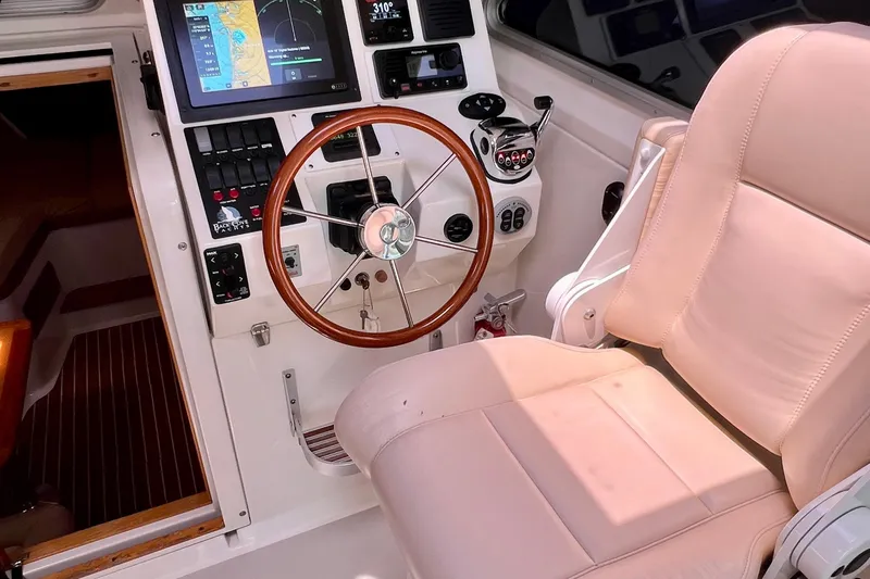 Cabrillo Yacht Photos Pics 2008 Back Cove 33 Express helm with steering wheel, navigation screens, and control panel.