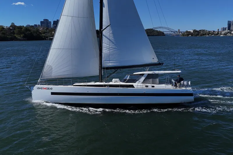 Long Time Dead Yacht Photos Pics 2017 Beneteau Oceanis Yacht 62 sailing on a sunny day, city skyline in background.