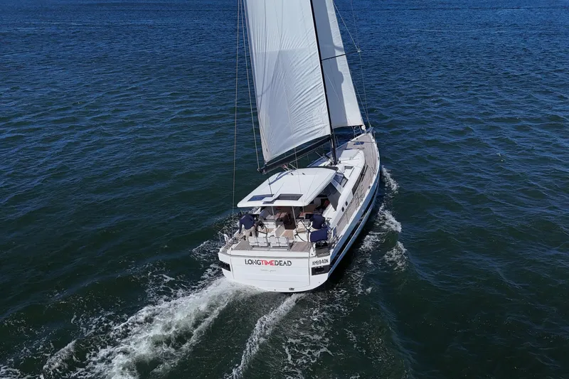 Long Time Dead Yacht Photos Pics 2017 Beneteau Oceanis Yacht 62 sailing on open water, viewed from above.
