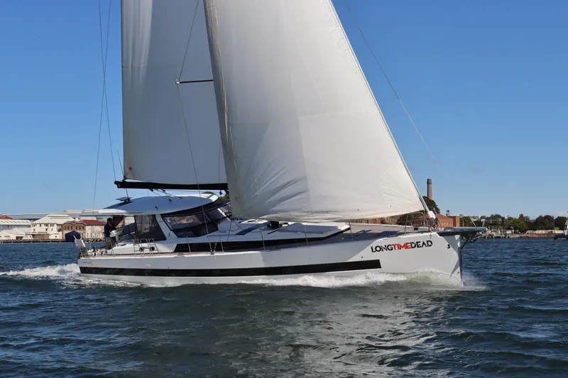 Long Time Dead Yacht Photos Pics 2017 Beneteau Oceanis Yacht 62 sailing on open water under clear blue skies.