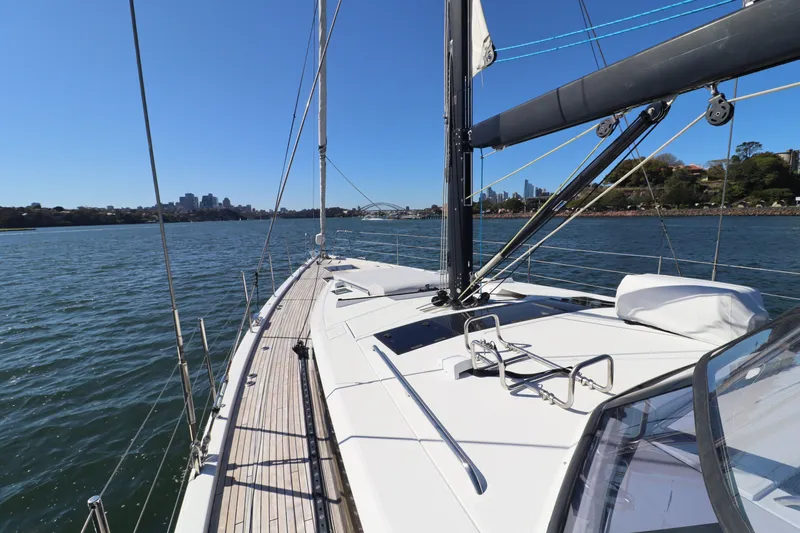 Long Time Dead Yacht Photos Pics 2017 Beneteau Oceanis Yacht 62 sailing on a sunny day, city skyline in background.