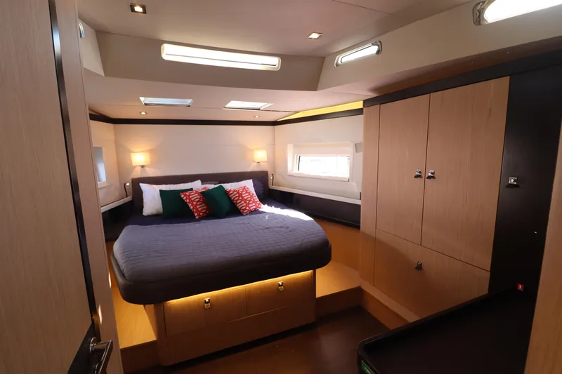 Long Time Dead Yacht Photos Pics Luxurious cabin interior of 2017 Beneteau Oceanis Yacht 62 with modern design and cozy bedding.
