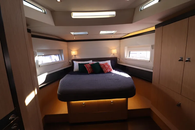 Long Time Dead Yacht Photos Pics Luxurious cabin interior of 2017 Beneteau Oceanis Yacht 62 with modern design and cozy bedding.